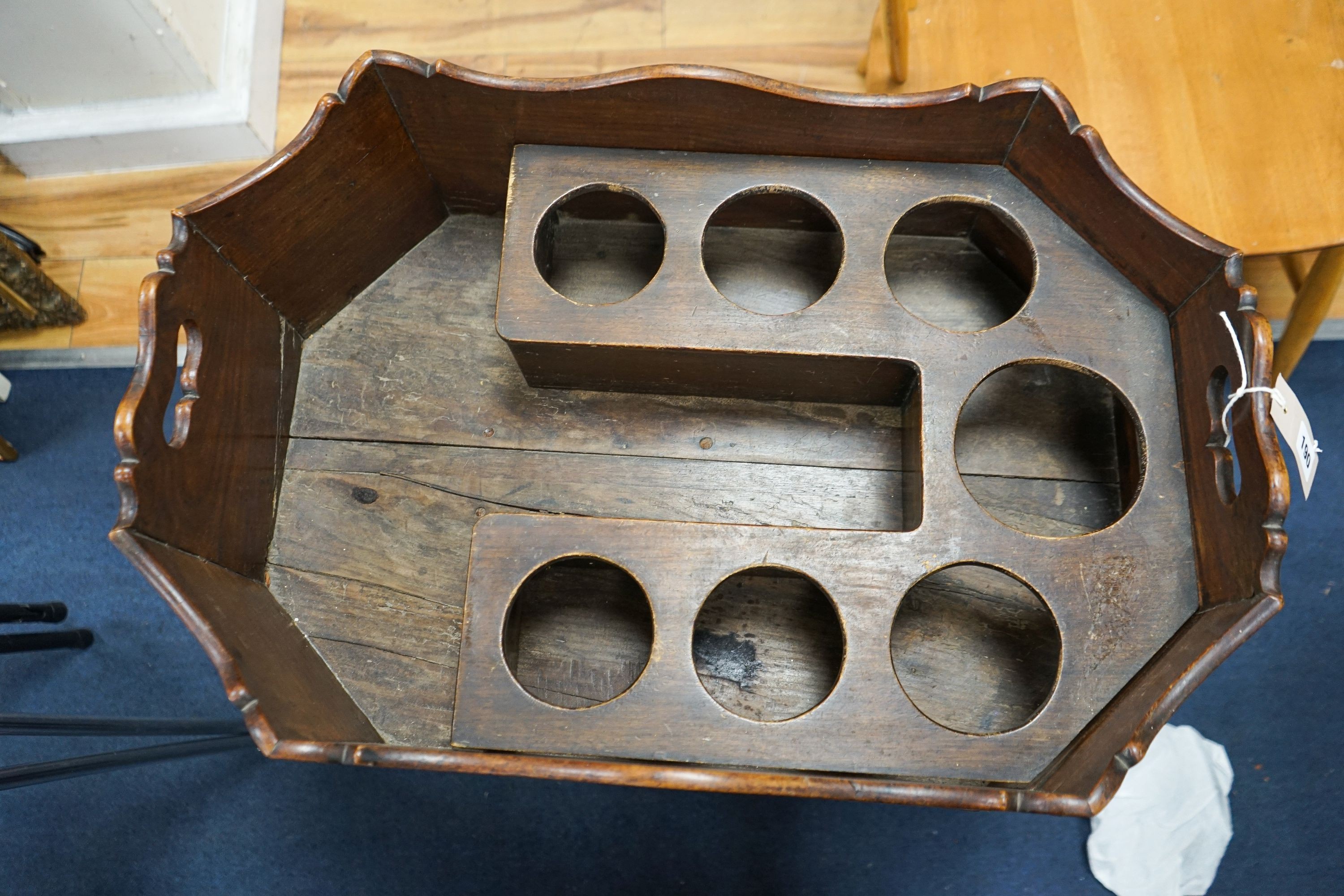 A Georgian cellarette or wine cooler of octagonal form, fitted for seven bottles, on four square legs with castors, width 66cm, depth 45cm, height 75cm